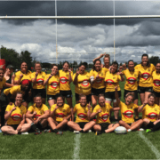 Group of Crusaders Rugby Club players posing for a team photo on a rugby field in Oakville, wearing yellow jerseys.