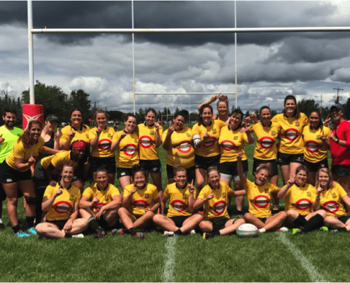 Group of Crusaders Rugby Club players posing for a team photo on a rugby field in Oakville, wearing yellow jerseys.