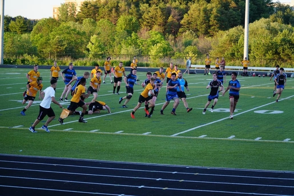 ORG_DSC09348 Crusaders Rugby Club players in blue and yellow jerseys practice on a green field in Oakville.