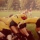 Crusaders Rugby Club players form a scrum on a grassy field in Oakville.