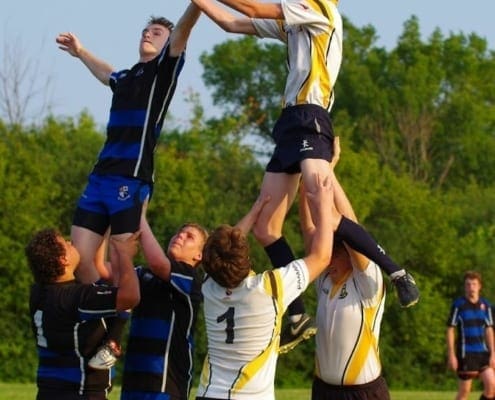 Crusaders Rugby Club players in Oakville lift teammates to catch the rugby ball in a line-out.