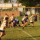 Youth rugby players from the Crusaders Rugby Club in Oakville compete on a grassy field.
