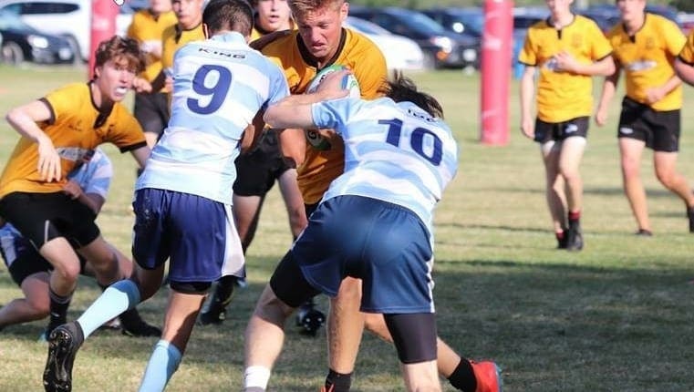 Crusaders Rugby Club players from Oakville contest the ball in an outdoor rugby match.