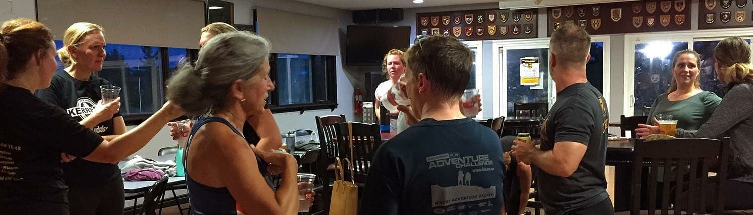 Crusaders Rugby Club members in Oakville socialize inside the clubhouse near a bar.