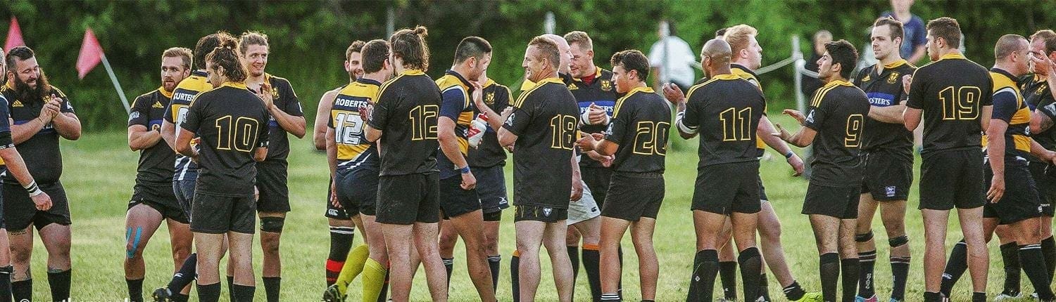 Crusaders Rugby Club players in black jerseys gather on a rugby field in Oakville. Crusaders Rugby Club players in black jerseys gather on a rugby field in Oakville.