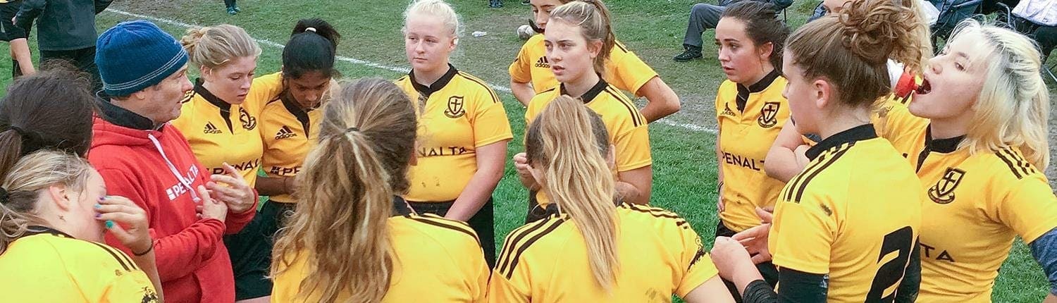 Crusaders Rugby Club players in Oakville huddle on the field in yellow jerseys. Crusaders Rugby Club players in Oakville huddle on the field in yellow jerseys.