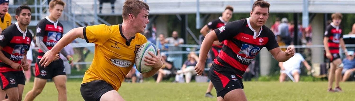 Rugby players from Crusaders Rugby Club Oakville play on a grassy field. Rugby players from Crusaders Rugby Club Oakville play on a grassy field.