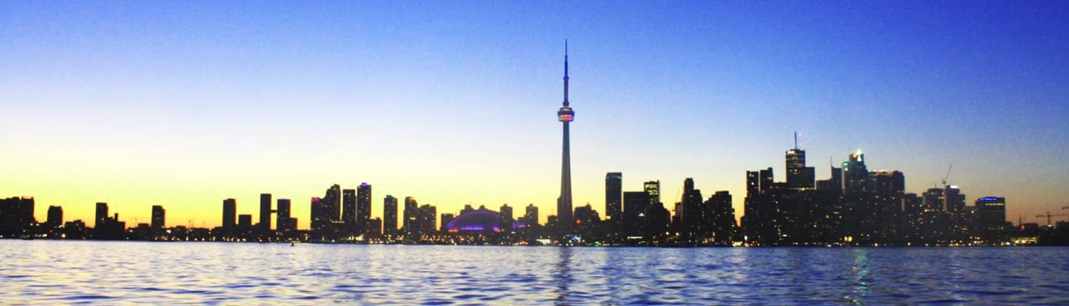 Toronto waterfront at sunset with the Toronto skyline and CN Tower on the horizon. Toronto waterfront at sunset with the Toronto skyline and CN Tower on the horizon.
