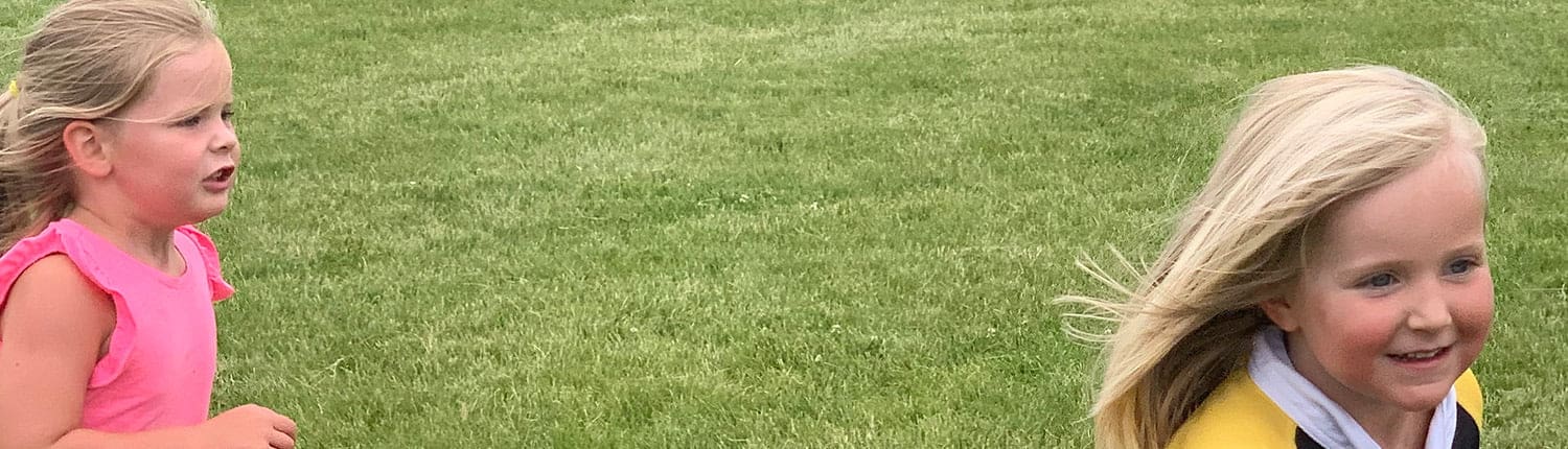 Two young girls run on a grassy rugby field, members of the Crusaders Rugby Club in Oakville. Two young girls run on a grassy rugby field, members of the Crusaders Rugby Club in Oakville.