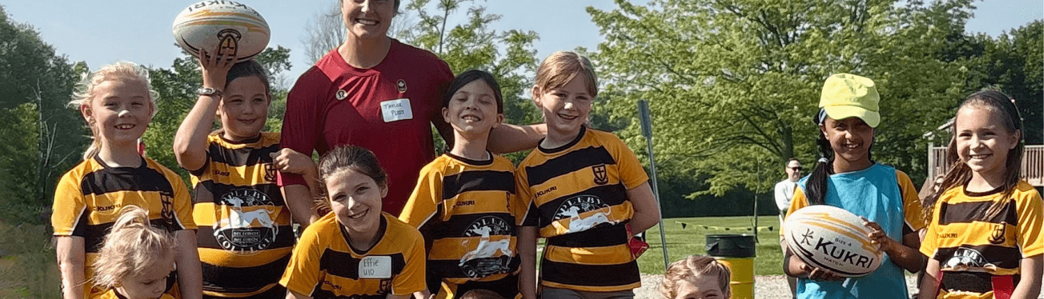 Crusaders Rugby Club Oakville youth team in black-and-gold jerseys with coach and rugby balls.