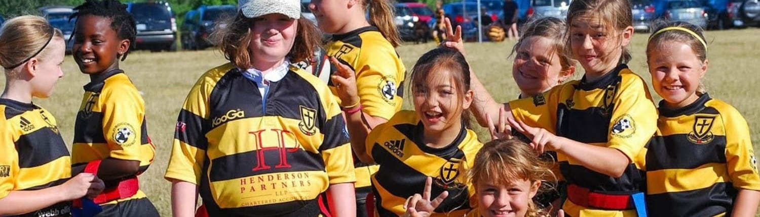 A group of youth rugby players from the Crusaders Rugby Club in Oakville pose together on a rugby field wearing yellow and black striped jerseys. A group of youth rugby players from the Crusaders Rugby Club in Oakville pose together on a rugby field wearing yellow and black striped jerseys.