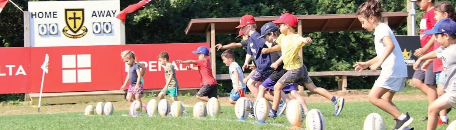 Crusaders Rugby Club players from Oakville sprint across a grassy field during a practice session.