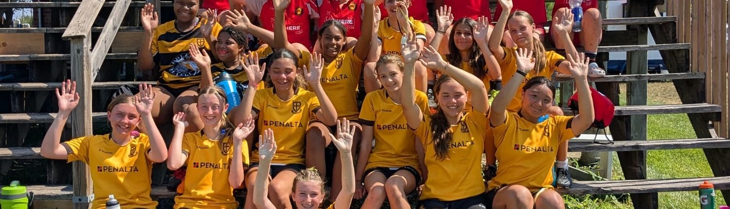 Crusaders Rugby Club players in yellow jerseys pose on outdoor wooden bleachers.