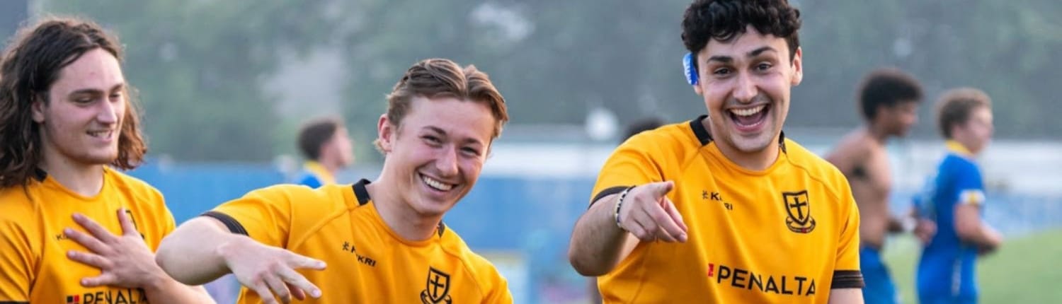 Crusaders Rugby Club players in yellow jerseys smiling during a practice on a field in Oakville. Crusaders Rugby Club players in yellow jerseys smiling during a practice on a field in Oakville.