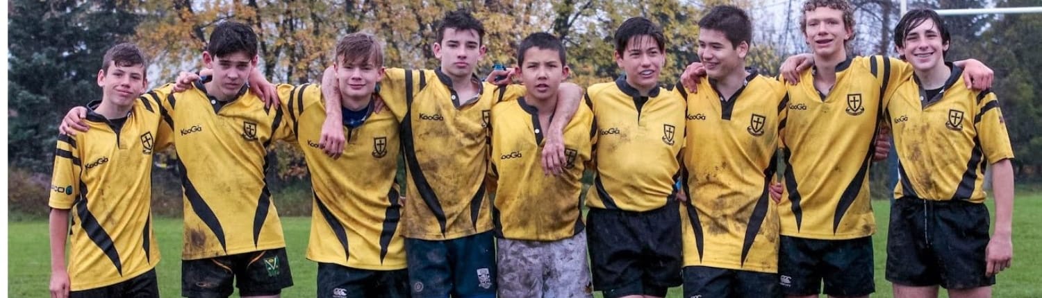 Group of Crusaders Rugby Club players in yellow and black uniforms posing together on a grassy field in Oakville. Group of Crusaders Rugby Club players in yellow and black uniforms posing together on a grassy field in Oakville.