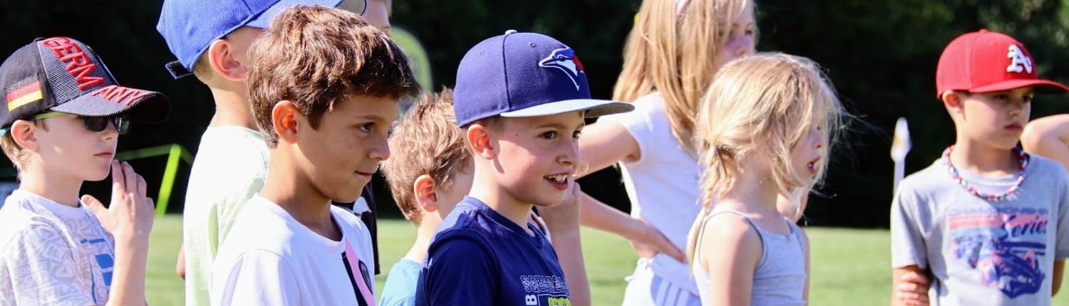 Young Crusaders Rugby Club players from Oakville stand together on a grassy field.